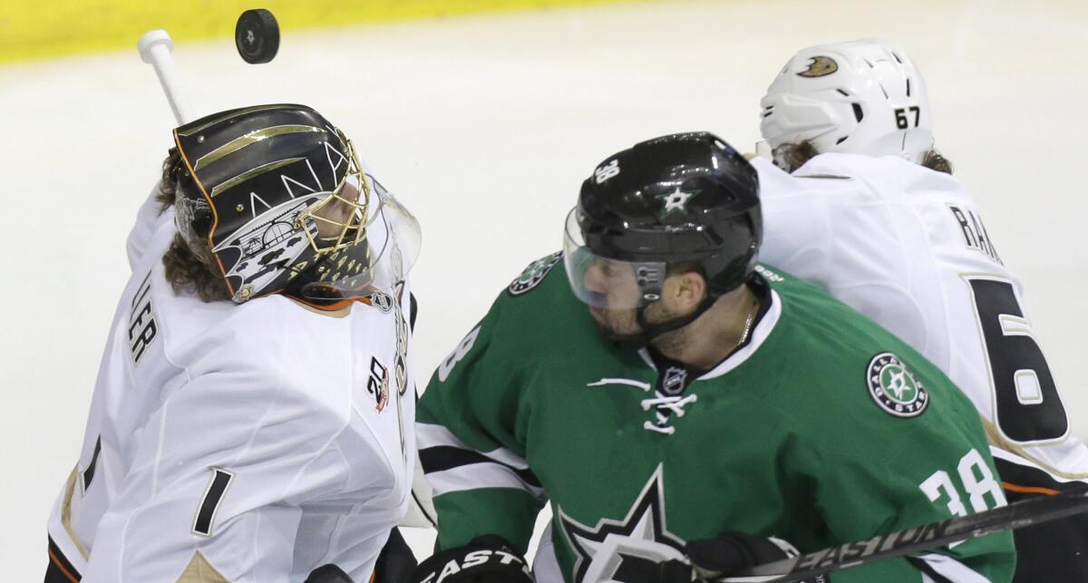 Ducks goalie Jonas Hiller makes a save in front of teammate Rickard Rakell, right, and Dallas Stars forward Vernon Fiddler during the third period of the Ducks' series-clinching 5-4 victory in Game 6 of the Western Conference quarterfinals on Sunday.