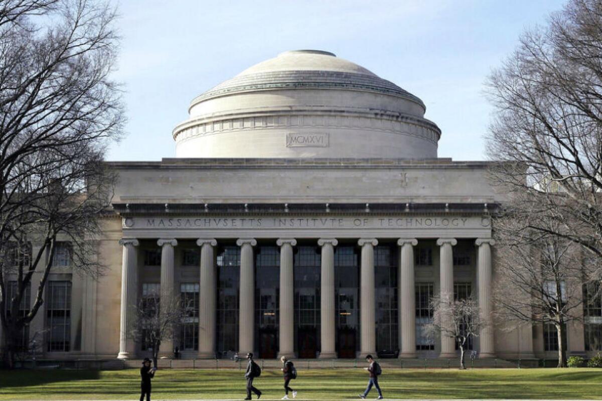 Students walk on the M.I.T. campus in Cambridge, Mass. 