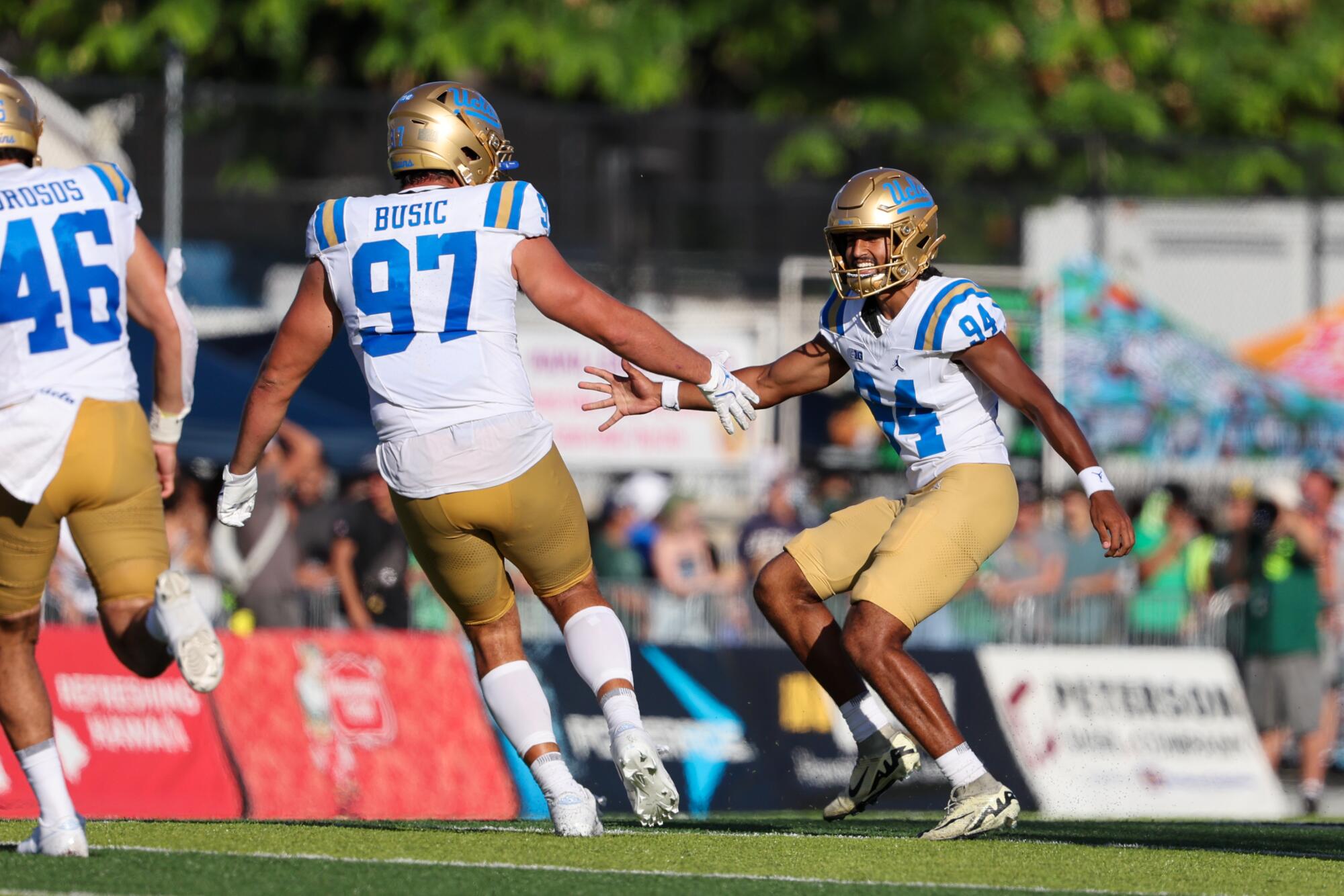 UCLA kicker Mateen Bhaghani, right, celebrates with lineman Jacob Busic after kicking the winning field goal.