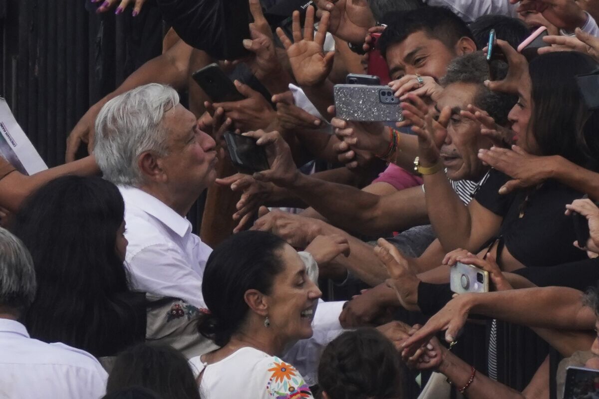 Mexican President Andrés Manuel López Obrador greets supporters as he arrives at the capital's main square