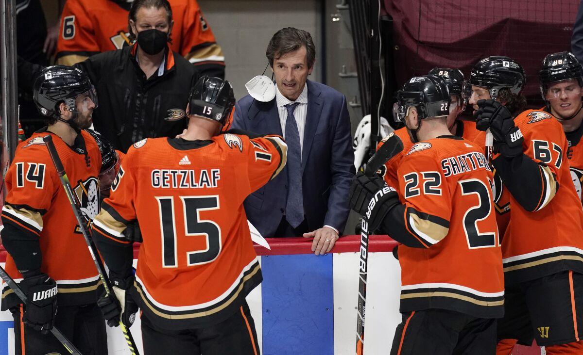 Anaheim Ducks head coach Dallas Eakins talks to players during a timeout.
