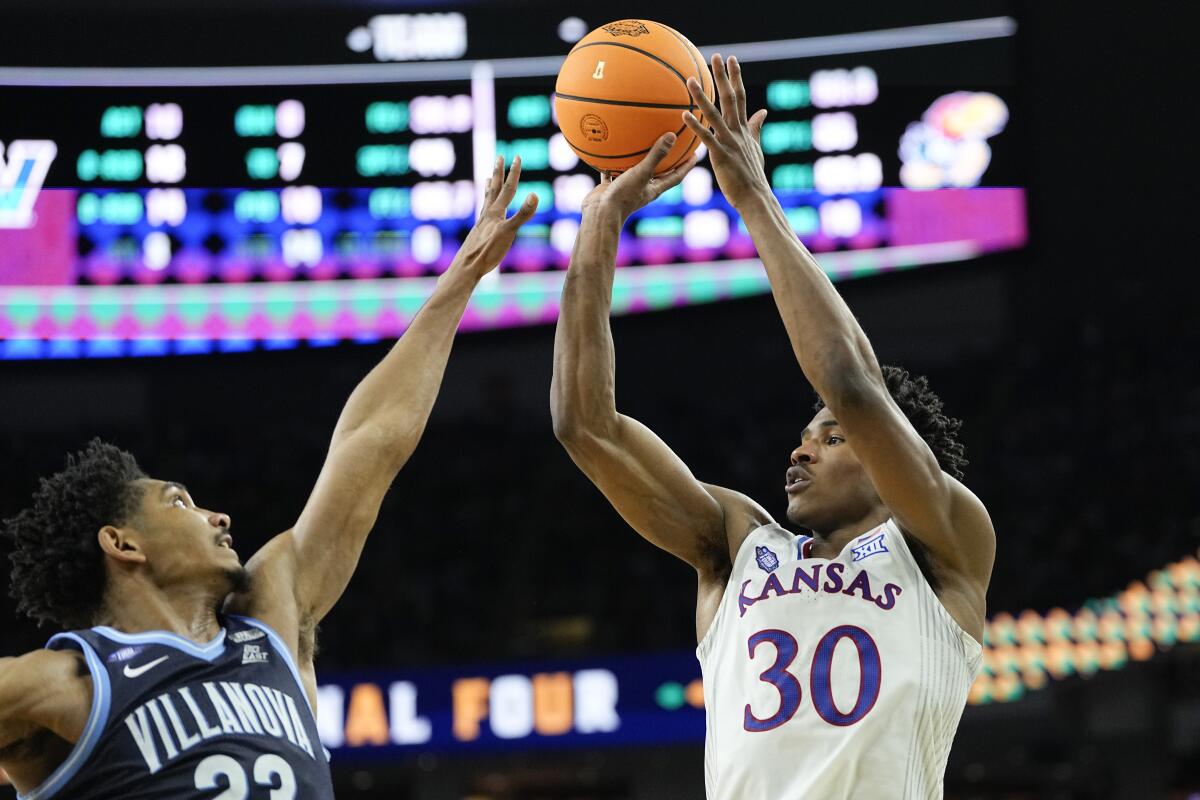 Kansas' Ochai Agbaji shoots over Villanova's Jermaine Samuels during the second half April 2, 2022.