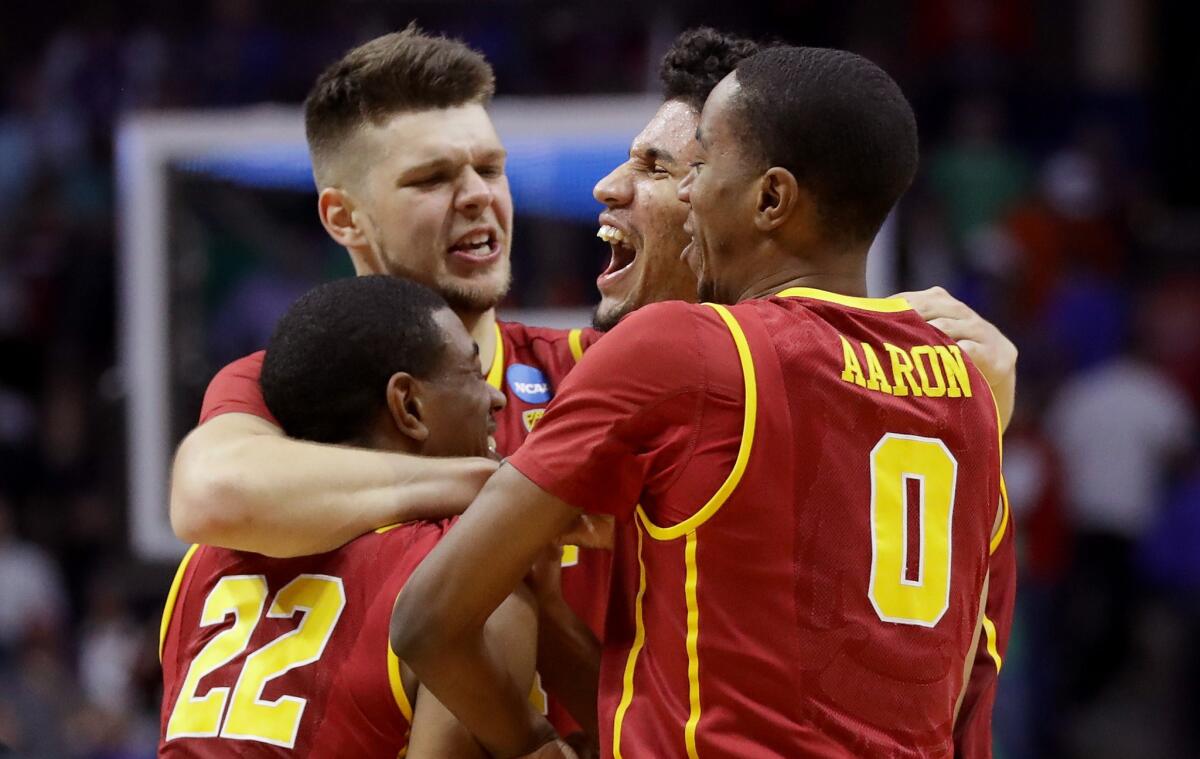 USC players (from left) De'Anthony Melton (22), Nick Rakocevic, Bennie Boatwright and Shaqquan Aaron (0) celebrate after defeating Southern Methodist, 66-65, to advance to the second round of the NCAA tournament.