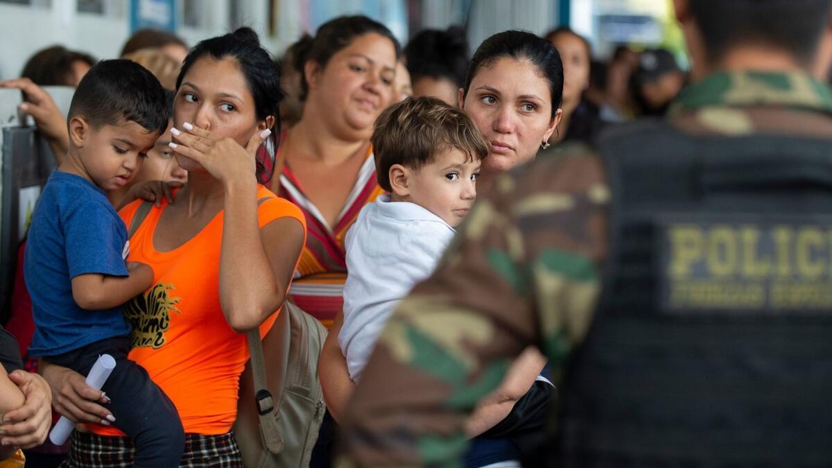Venezuelan migrants await refugee applications at a Peruvian border post Friday. Some 6,000 Venezuelans have entered Peru in the last two days, twice the recent pace. The UNHCR has called for regional talks to address migration in the Americas.