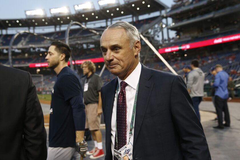 Commissioner of Major League Baseball Rob Manfred walks on the field during batting practice before a National League wild card baseball game between the Milwaukee Brewers and the Washington Nationals, Tuesday, Oct. 1, 2019, in Washington. (AP Photo/Patrick Semansky)
