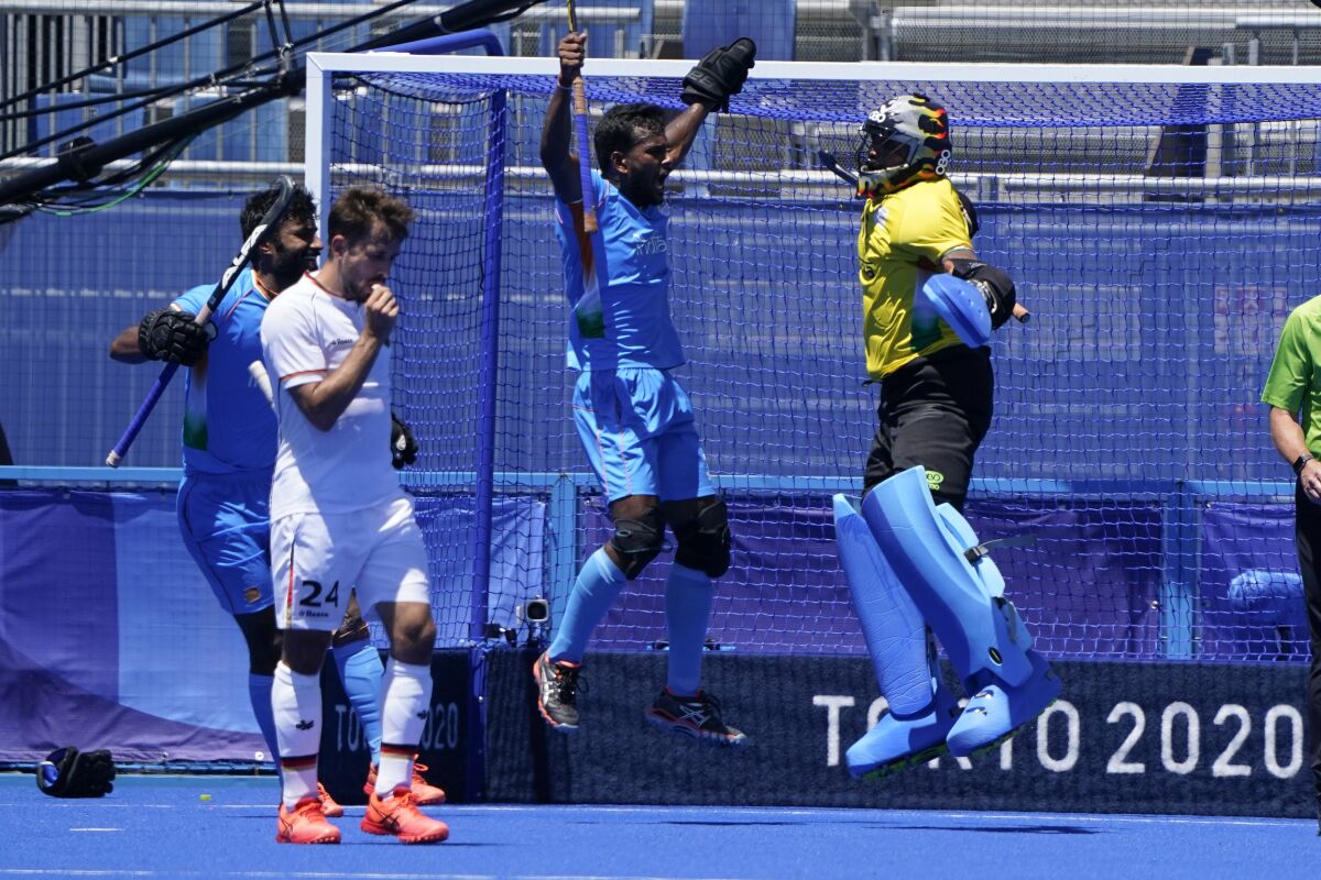 India goalkeeper Sreejesh Parattu Raveendran, center, celebrates after making a save as Germany's Benedikt Furk, second from left, looks on during the men's field hockey bronze medal match at the 2020 Summer Olympics, Thursday, Aug. 5, 2021, in Tokyo, Japan. (AP Photo/John Minchillo)