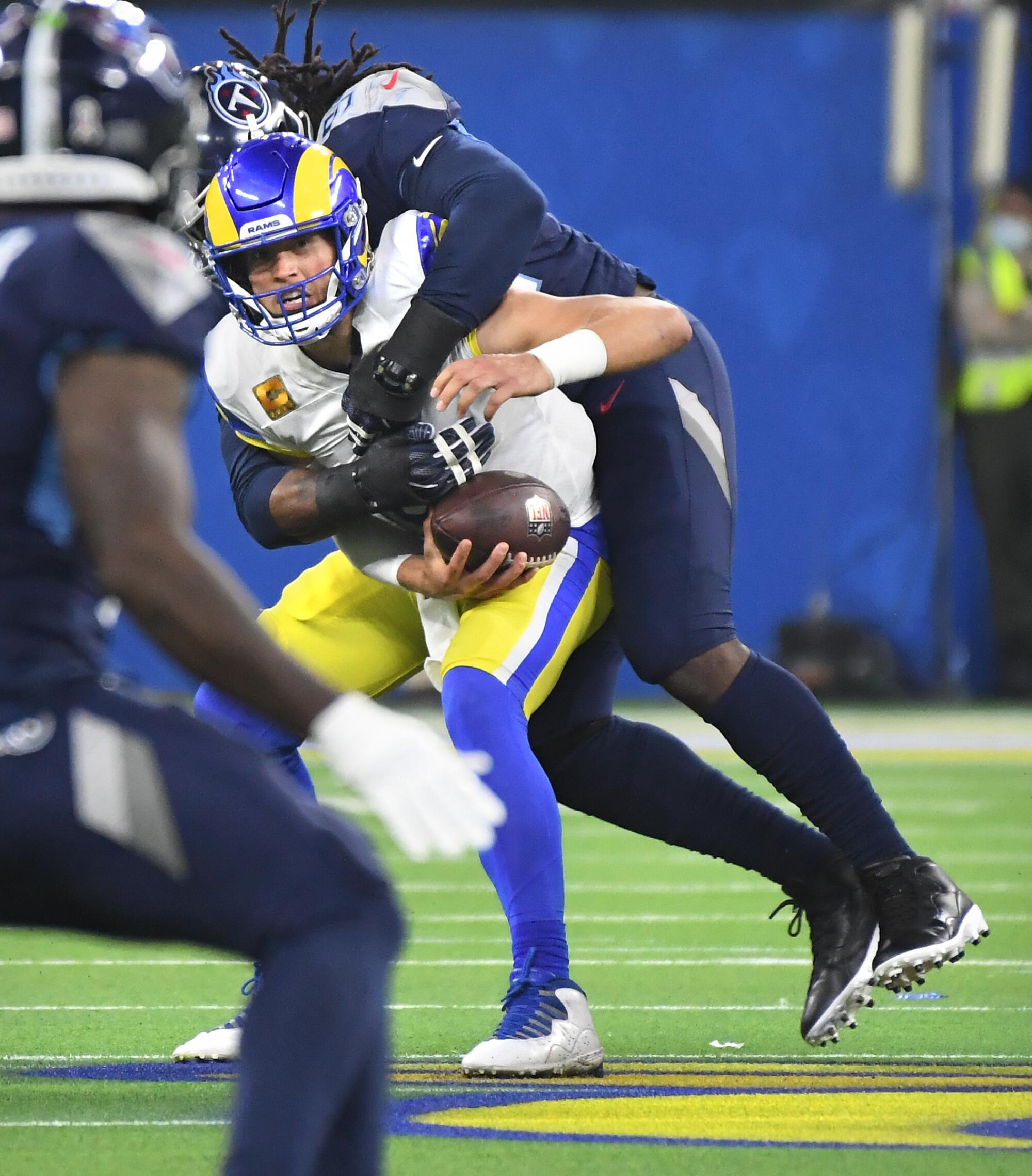Rams quarterback Matthew Stafford is sacked by Tennessee Titans defensive end Denico Autry.