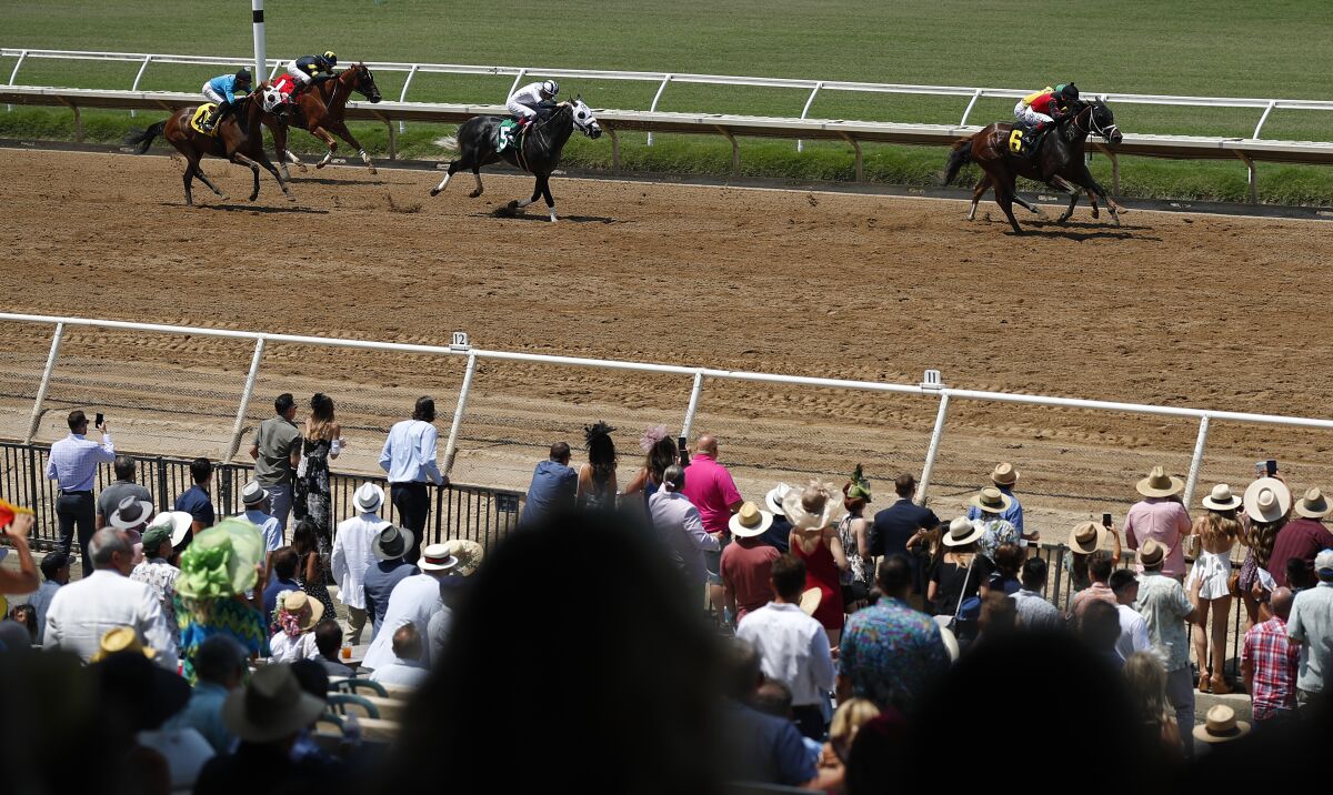  Horses come into the finish for the first race of the 2021 season at the Del Mar Thoroughbred Club Friday. 