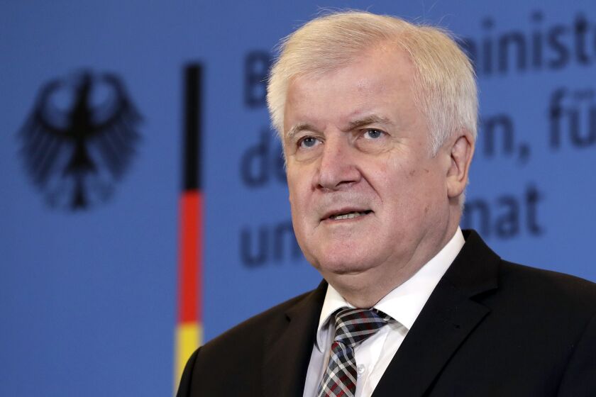 FILE -- In this Monday, Nov. 5, 2018 photo German Interior Minister Horst Seehofer addresses the media during a press conference in Berlin, Germany. Police have raided homes in three German states after the German government banned a far-right group, the interior ministry said. “Whoever fights against the basic values of our free society will get to feel the resolute reaction of our government,” Interior Minister Horst Seehofer said. “There's no place in this country for an association that sows hatred and and works on the resurrection of a Nazi state.” (AP Photo/Michael Sohn, file)