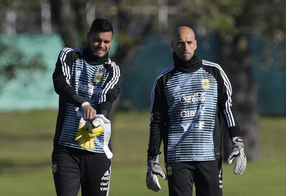 Argentina's national team goalkeepers Sergio Romero (L) and Willy Caballero, arrive to a training session in Ezeiza, Buenos Aires on May 22, 2018. The Argentinian team is training ahead of a friendly match against Haiti to be held on May 29 at "La Bombonera" stadium in Buenos Aires, before departing to Barcelona, to prepare for the upcoming FIFA World Cup 2018 in Russia.