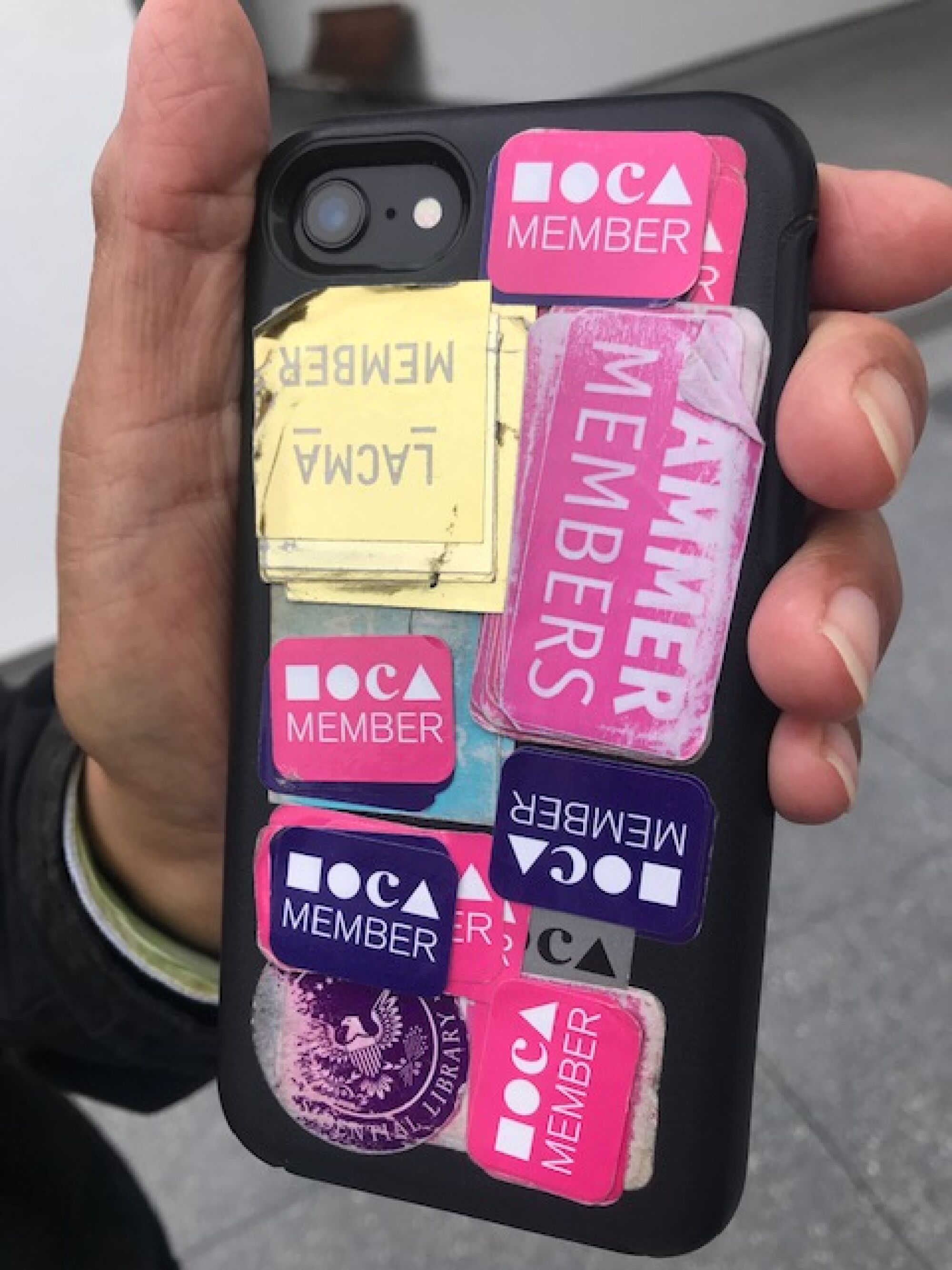 The back of Ben Barcelona's phone, which features layers of museum membership stickers, a testament to his devotion.