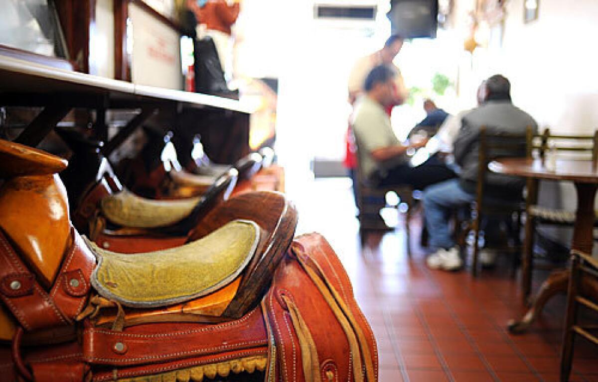 RIDE, VAQUERO: Saddles serve as seats at Ramón and Lourdes Peñas snug, rancho-inflected Santa Ana restaurant.