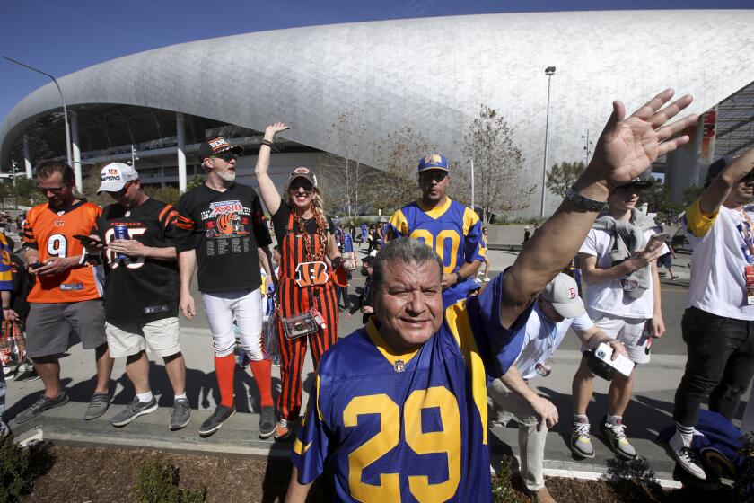 Inglewood, CA - February 13: Rams and Benals fans stand outside of SoFi Stadium before Super Bowl LVI on Sunday, Feb. 13, 2022 in Inglewood, CA.(Luis Sinco / Los Angeles Times)