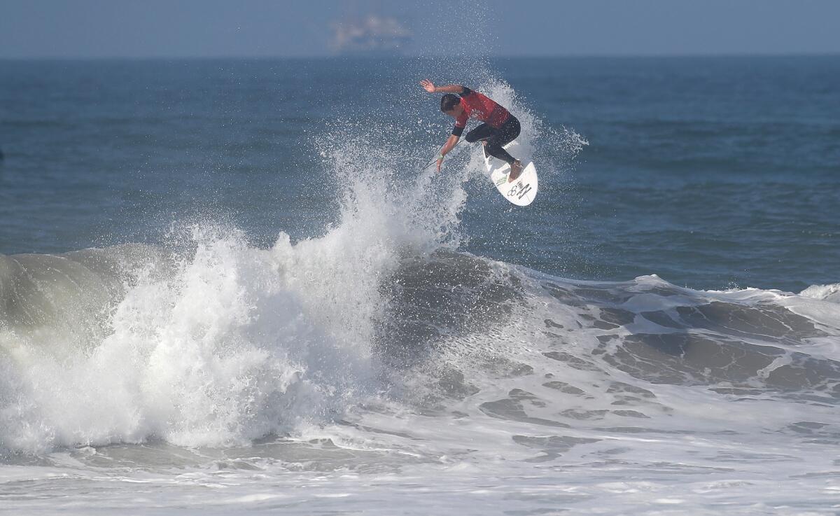 Eithan Osborne completes a backside air as he competes in the second round of the  U.S. Open of Surfing men's competition.