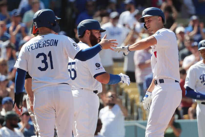 LOS ANGELES, CA - SEPTEMBER 8, 2019:Los Angeles Dodgers shortstop Corey Seager (5) gets high-fives from Los Angeles Dodgers Joc Pederson (31) and Los Angeles Dodgers Russell Martin (55)after hitting a 3-run home run to give the Dodgers a 5-0 lead against the San Francisco Giants in the fifth inning at Dodger Stadium on September 8, 2019 in Los Angeles, California. (Gina Ferazzi/Los AngelesTimes)