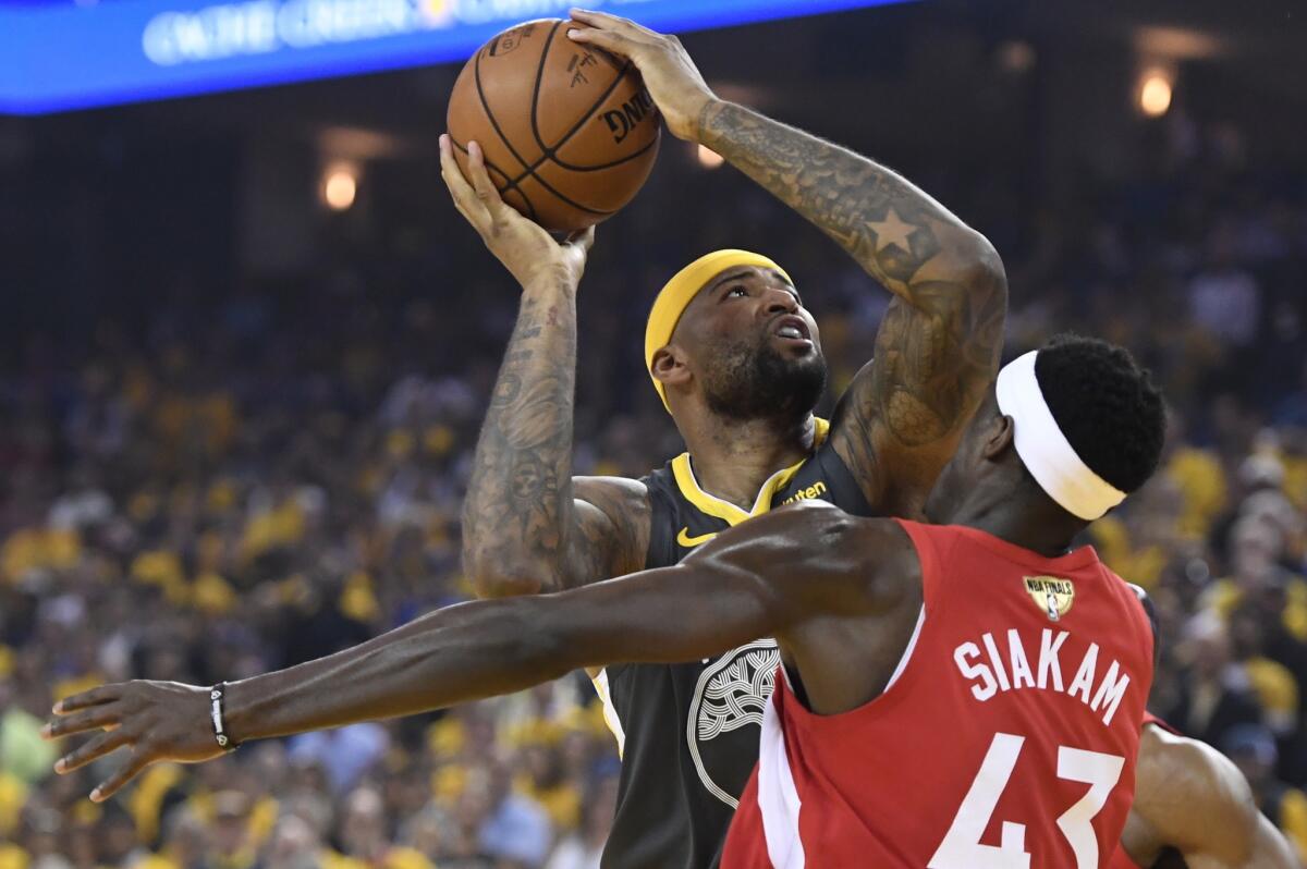 Golden State Warriors center DeMarcus Cousins goes up for a shot over Toronto Raptors forward Pascal Siakam (43) during the first half of Game 6 of basketball’s NBA Finals, Thursday, June 13, 2019, in Oakland, Calif.