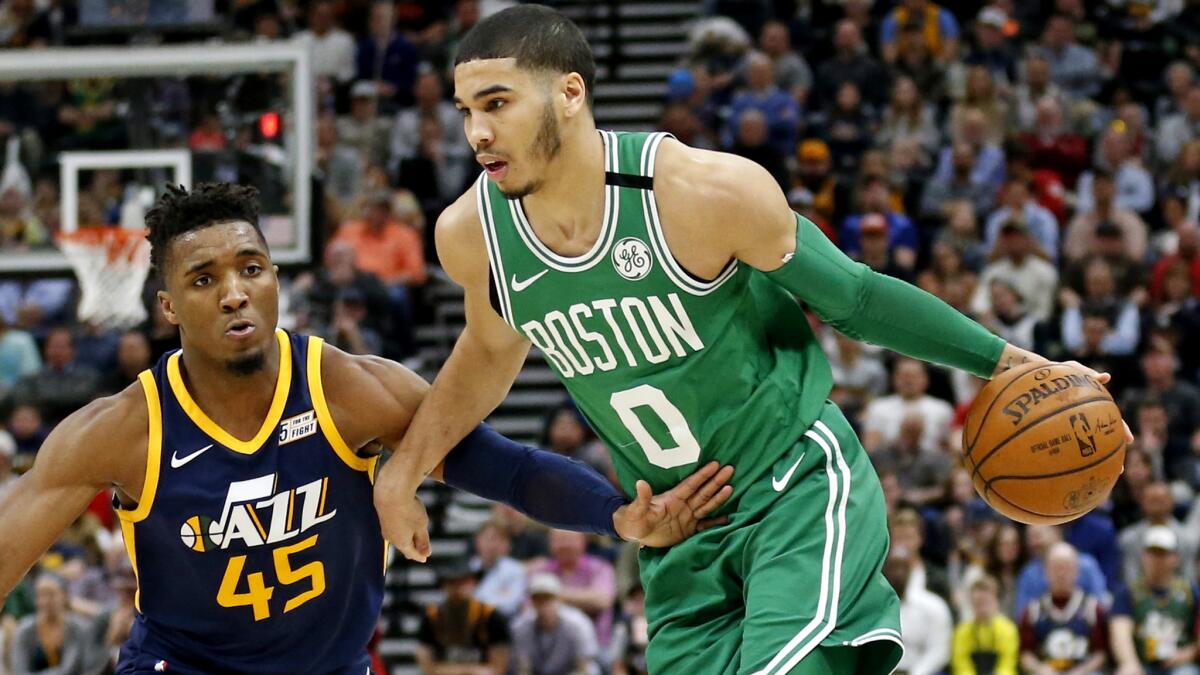 Celtics forward Jayson Tatum (0), driving against another rookie star in the Jazz's Donovan Mitchell, has been called the NBA rookie of the year by teammate Al Horford.