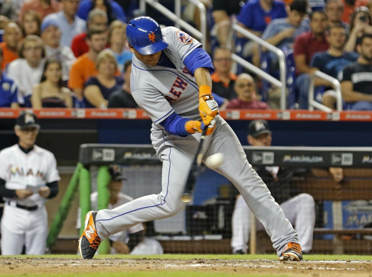 Juan Lagares hits a triple for the New York Mets in 2015. The 30-year-old outfielder signed a minor-league deal with the Padres on Monday.