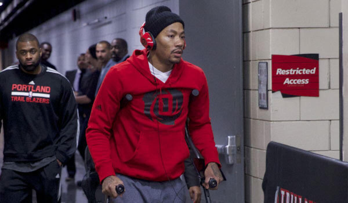 Chicago's Derrick Rose leaves the Moda Center on crutches after he was injured during the Bulls' game against Portland.