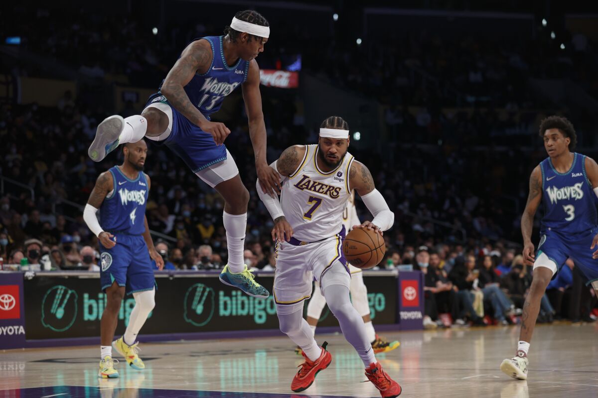 Nathan Knight gets airborne as Carmelo Anthony presses forward.
