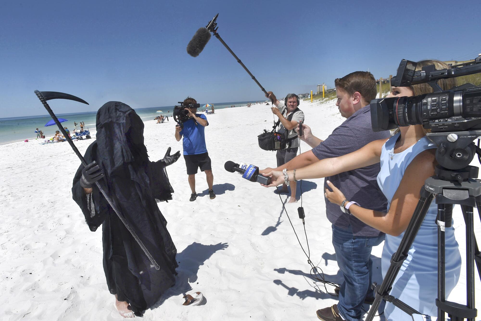 Florida attorney Daniel Uhlfelder, dressed as the Grim Reaper, talks with reporters at a beach near Destin, Fla., on May 1.