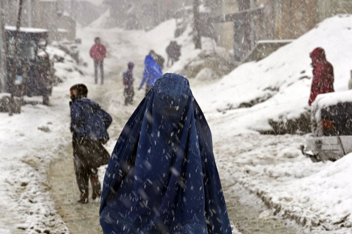 People walk in the snow in Kabul, Afghanistan.
