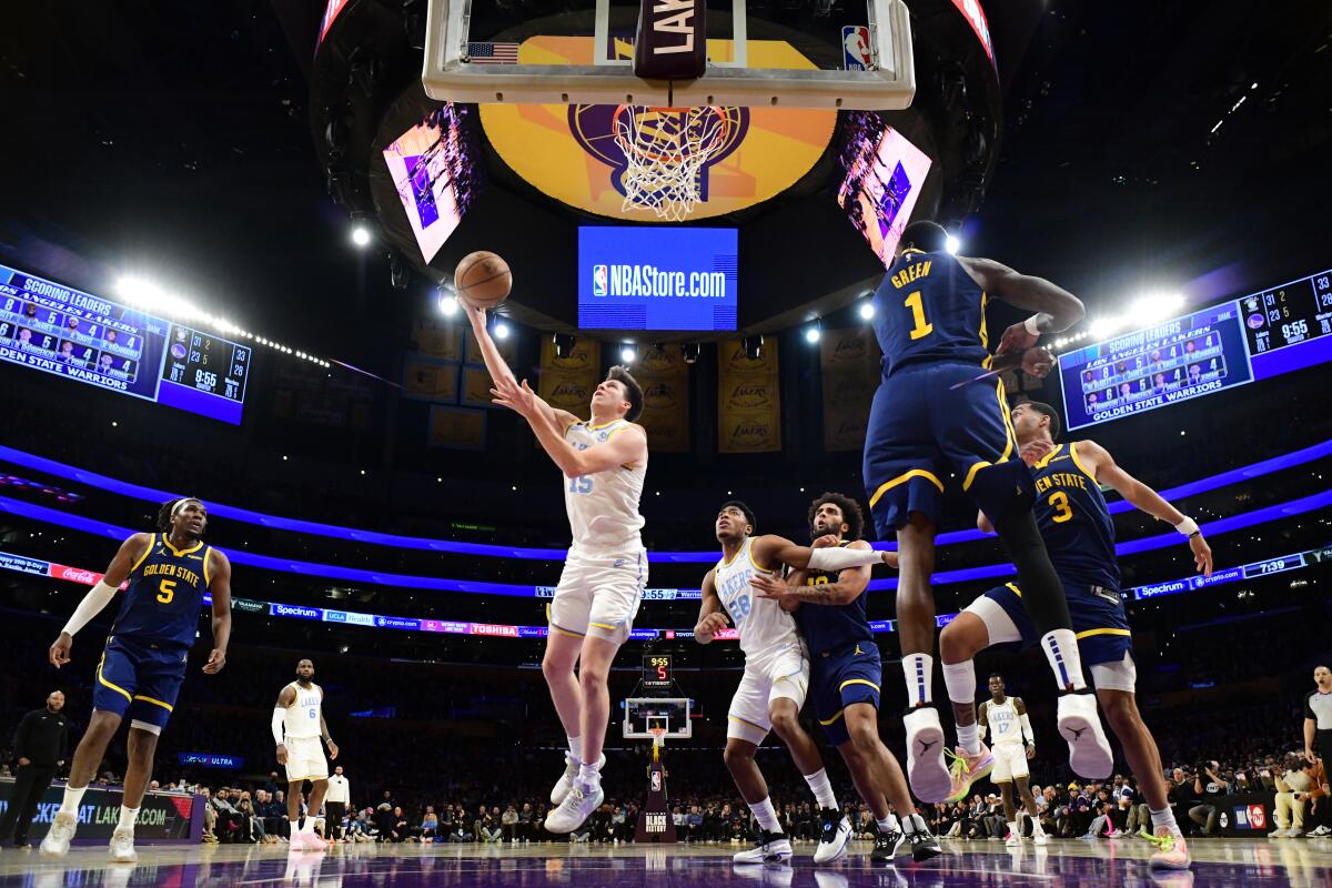 Lakers guard Austin Reaves beats the Warriors defense for a layup.
