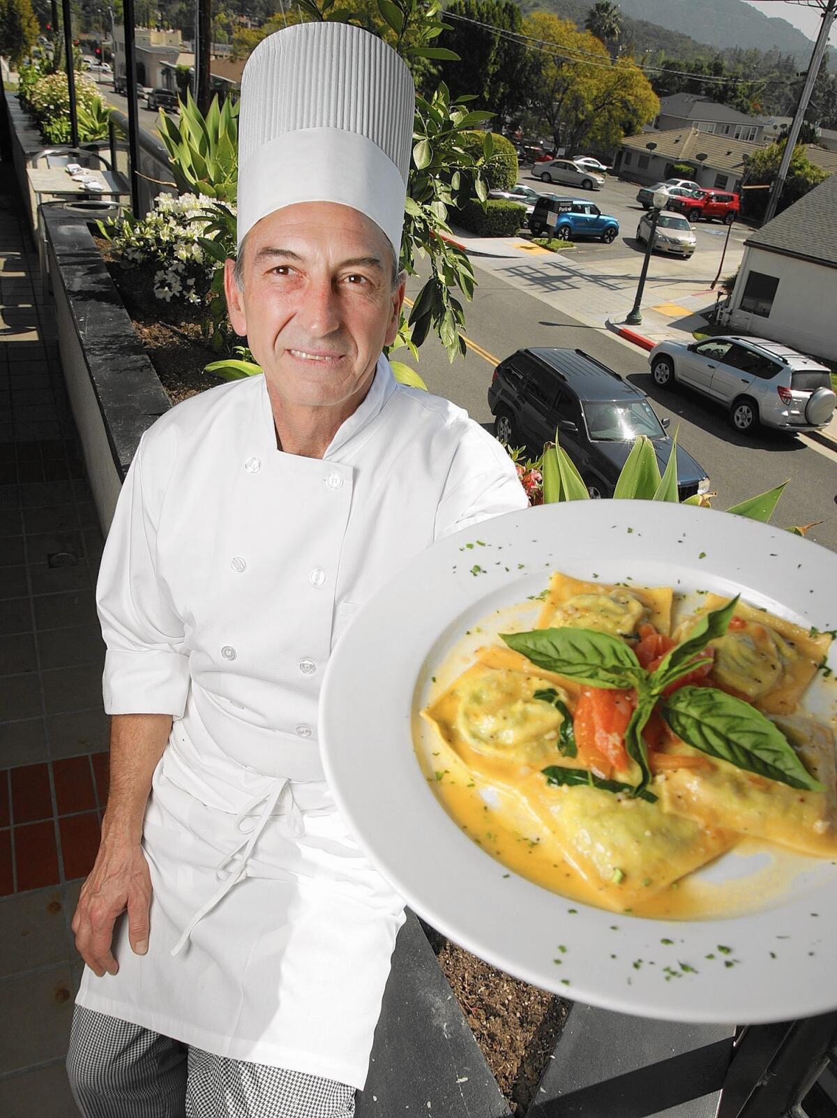 Chef and owner Fausto Tinelli holds a plate of ravioli with ricotta cheese and spinach at Trattoria Allegria in Montrose on Thursday, March 17, 2016.