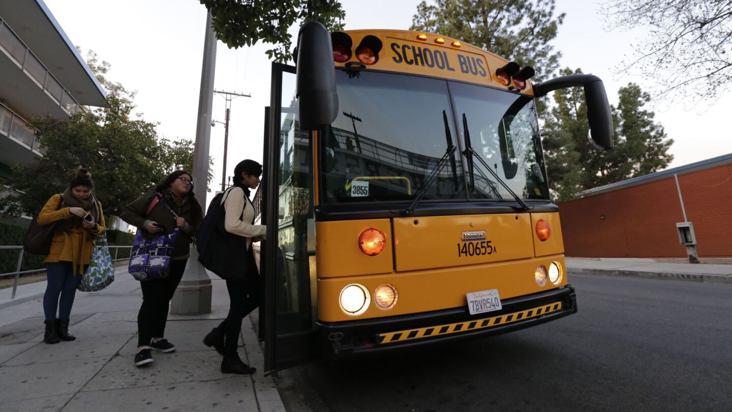 Student board a bus in front of Franklin High School in Los Angeles as schools reopen on Wednesday.