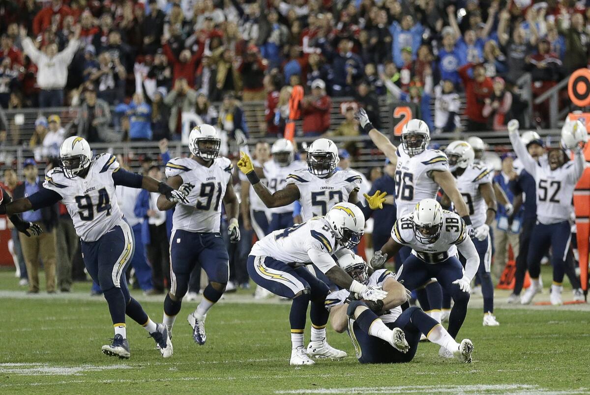 Chargers players celebrate after Sean Lissemore, on ground, recovered a fumble by San Francisco 49ers wide receiver Quinton Patton during overtime.