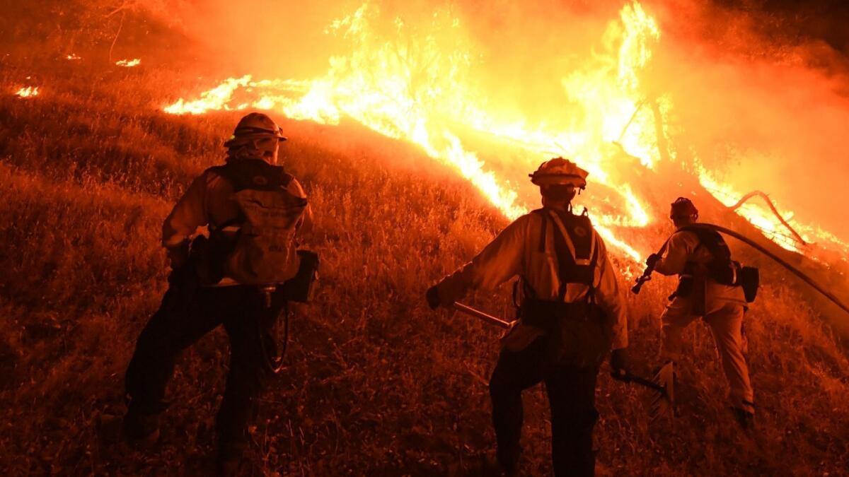 Verizon Wireless said it will stop imposing data speed restrictions on first responders on the West Coast after firefighters complained their data was being throttled by the company. In this file photo, firefighters conduct a controlled burn to defend houses from the Ranch fire.
