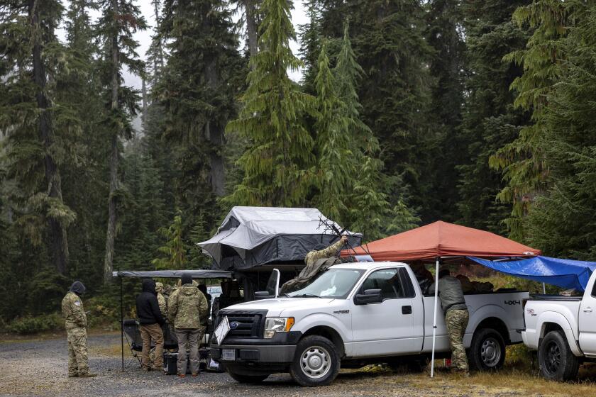 About 30 members of the U.S. Army's 1st Special Forces Group, Airborne Division meet for a search and rescue operation for the two missing Navy aviators on Friday, Oct. 18, 2024, near Goose Prairie, Yakima County, Wash. (Nick Wagner/The Seattle Times via AP)