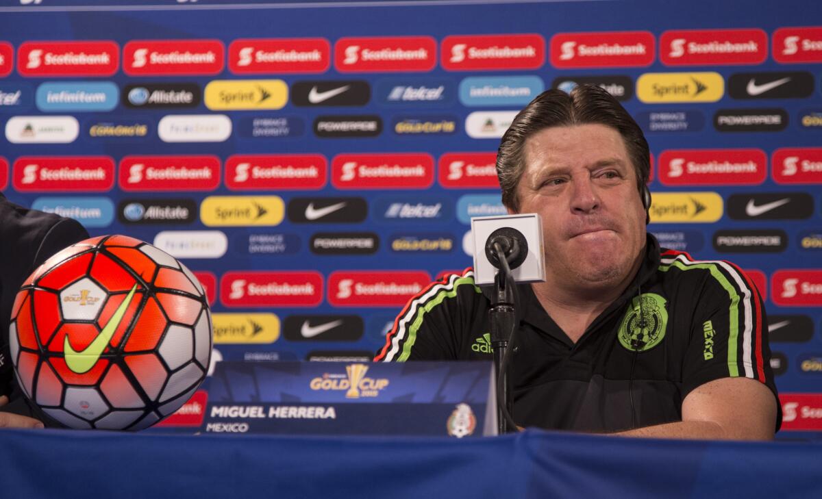Miguel Herrera speaks during a news conference before a Gold Cup game.
