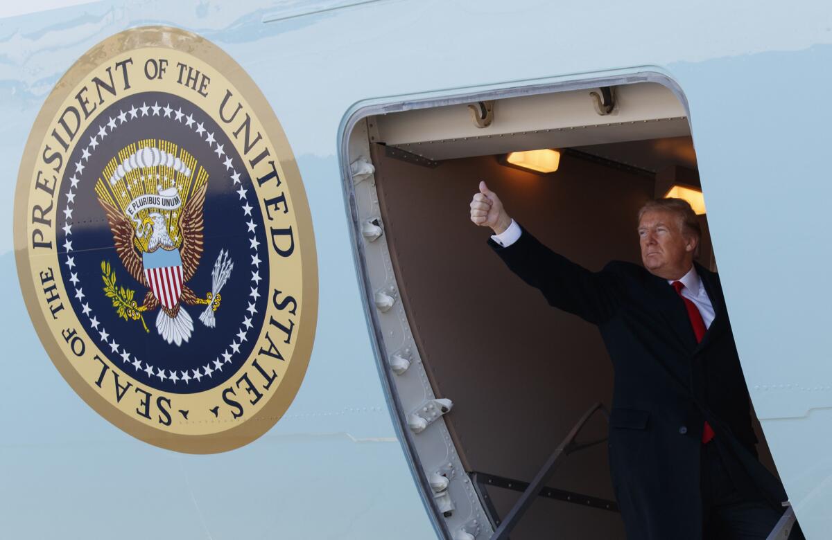 President Donald Trump boards Air Force One for a trip to California to view border wall prototypes.