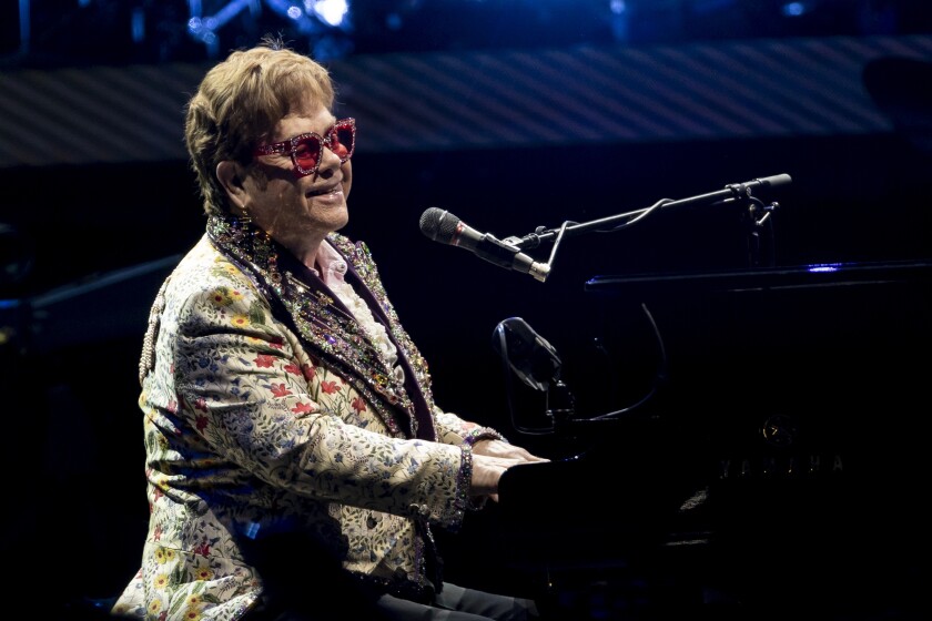 FILE - Elton John performs during his "Farewell Yellow Brick Road" tour on Wednesday, Jan. 19, 2022, in New Orleans. Despite being vaccinated and boosted, John has contracted COVID-19 and is postponing two farewell concert dates in Dallas. John “is experiencing only mild symptoms,” according to a statement. (AP Photo/Derick Hingle, File)