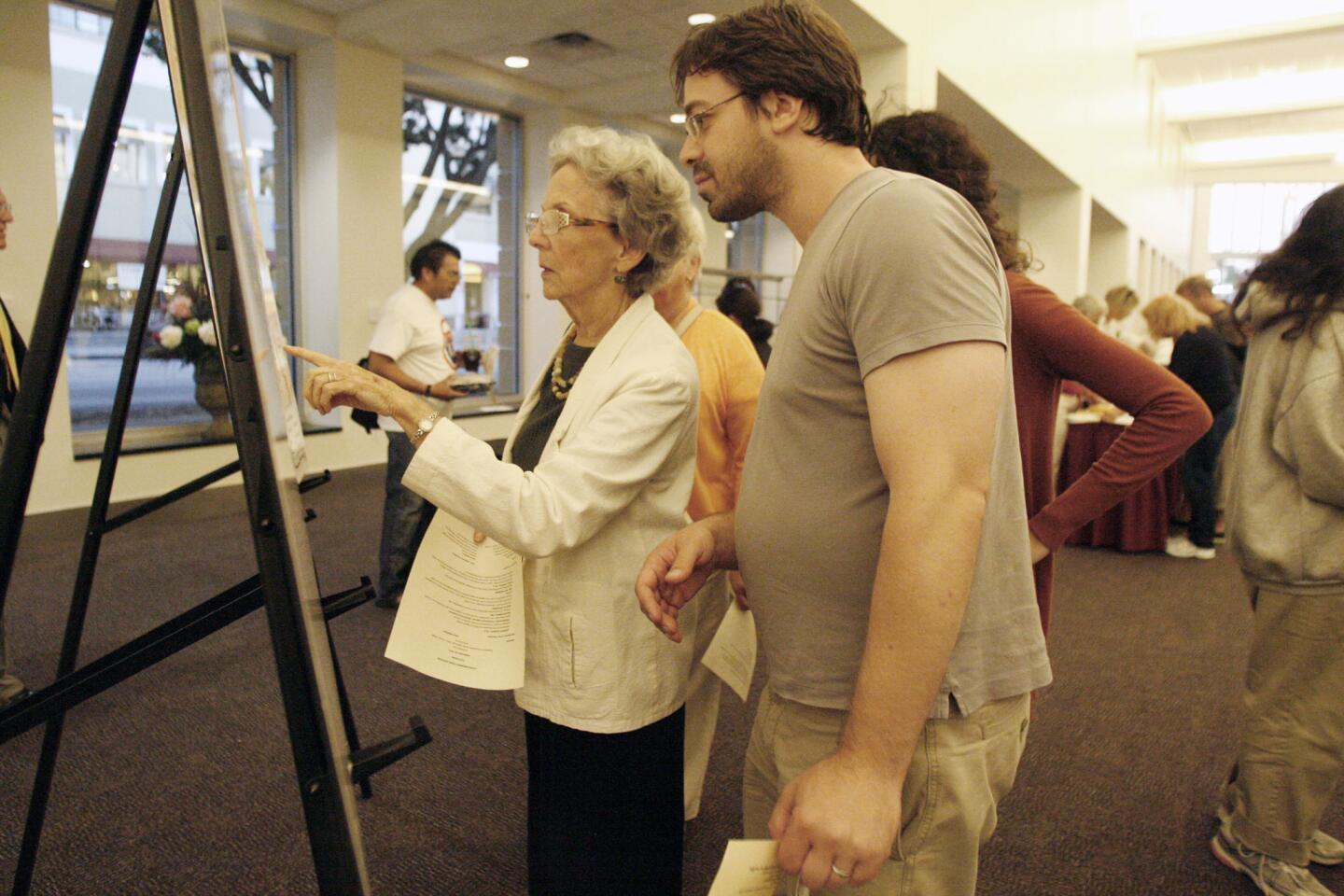 Connie Haddad, left, and Robert Granat put a sticker on a map during a panel discussion about the 710 freeway extension proposal, which took place at the Pasadena Convention Center on Tuesday, September 18, 2012.