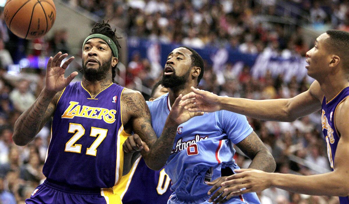 Lakers center Jordan Hill (27) battles Clippers center DeAndre Jordan for a rebound along with teammate Wesley Johnson during a game last season. They renew the Staples Center rivalry on Friday night.