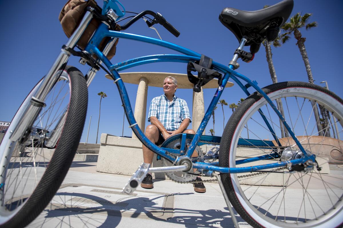 Chris Hill typically rides his bike more than 20 miles per day in Surf City.