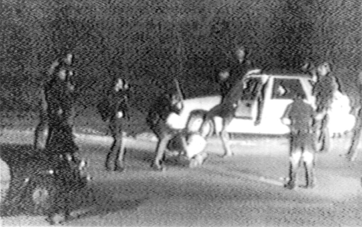 A still image taken from George Holliday's 1991 video shows police officers beating a man, later identified as Rodney King.