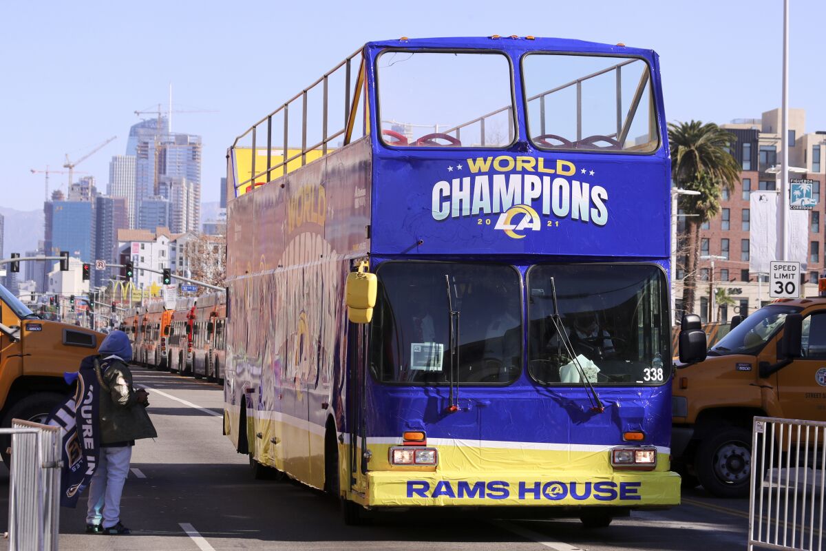 A bus with a World Champions display sits on the street in Los Angeles.