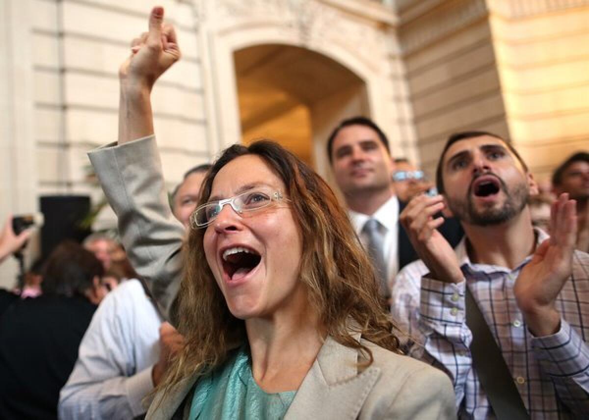 Supporters of same-sex marriage cheer at San Francisco City Hall on Wednesday as they learn results of the U.S. Supreme Court's rulings on gay marriage.