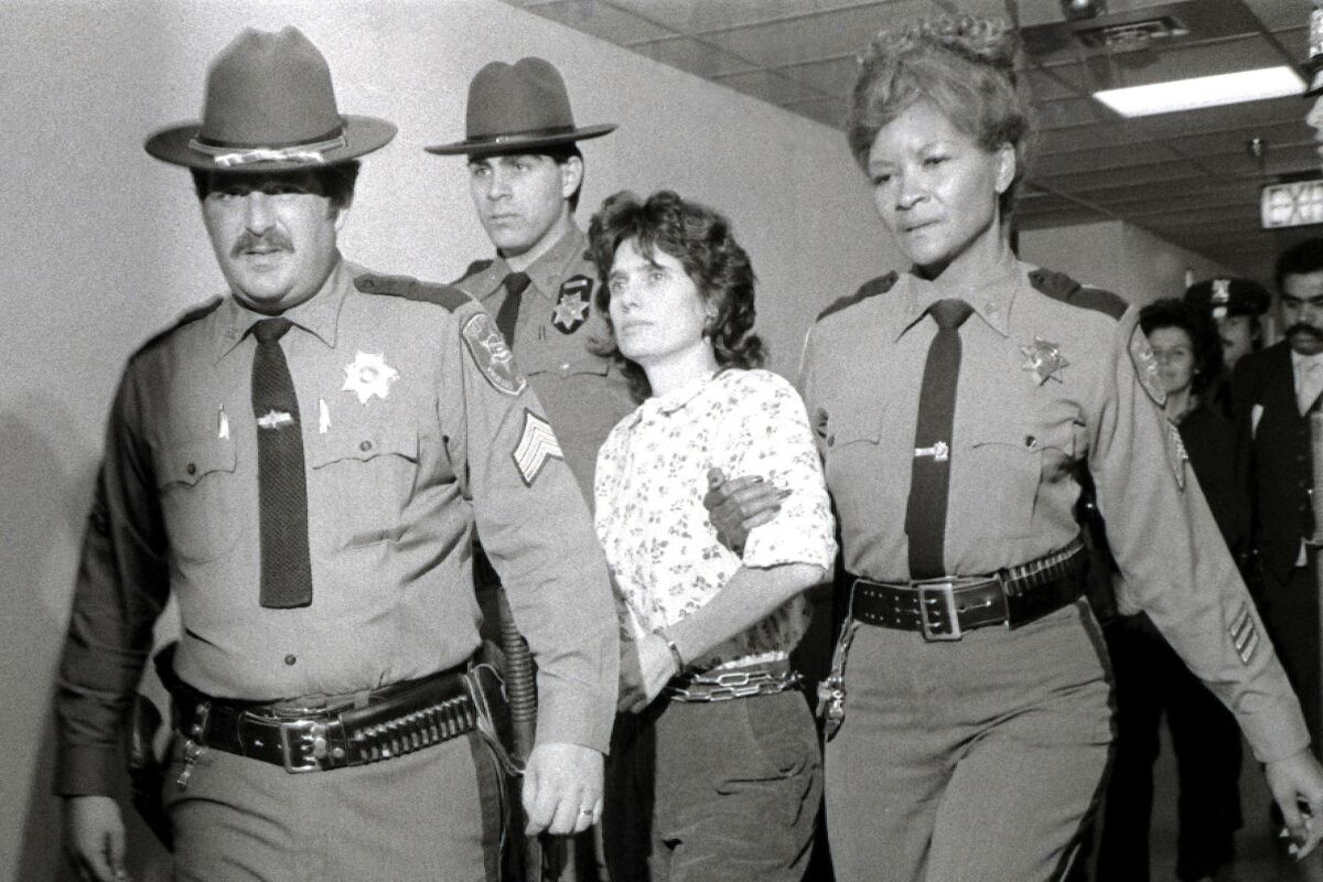 FILE - In this Nov. 21, 1981 file photo, Weather Underground member Katherine Boudin is led from Rockland County Courthouse in New City, New York, by sheriff's officers. Boudin, a former member of the radical Weather Underground who spent more than two decades in prison for her role in a fatal 1981 armored truck robbery and then spent decades helping other inmates, has died at age 78. (AP Photo/Handschuh, File)