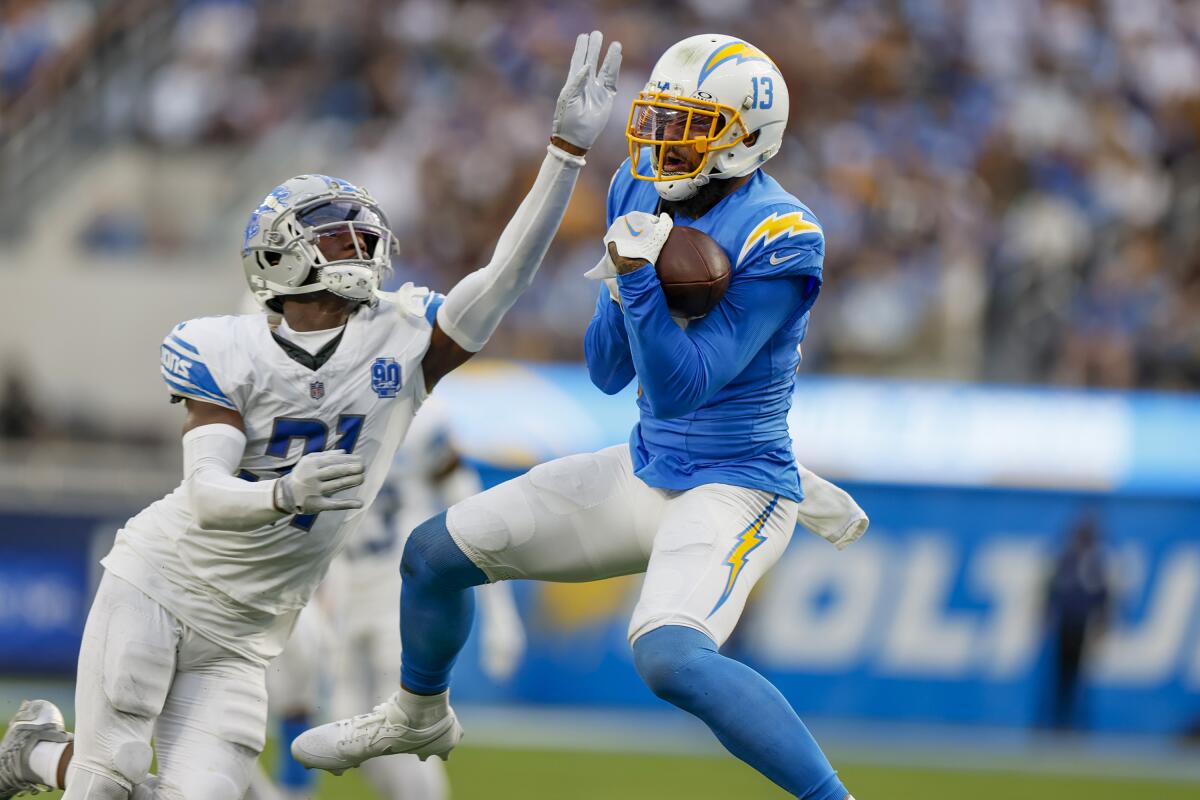 Chargers wide receiver Keenan Allen makes a leaping catch in front of Detroit Lions safety Tracy Walker III.