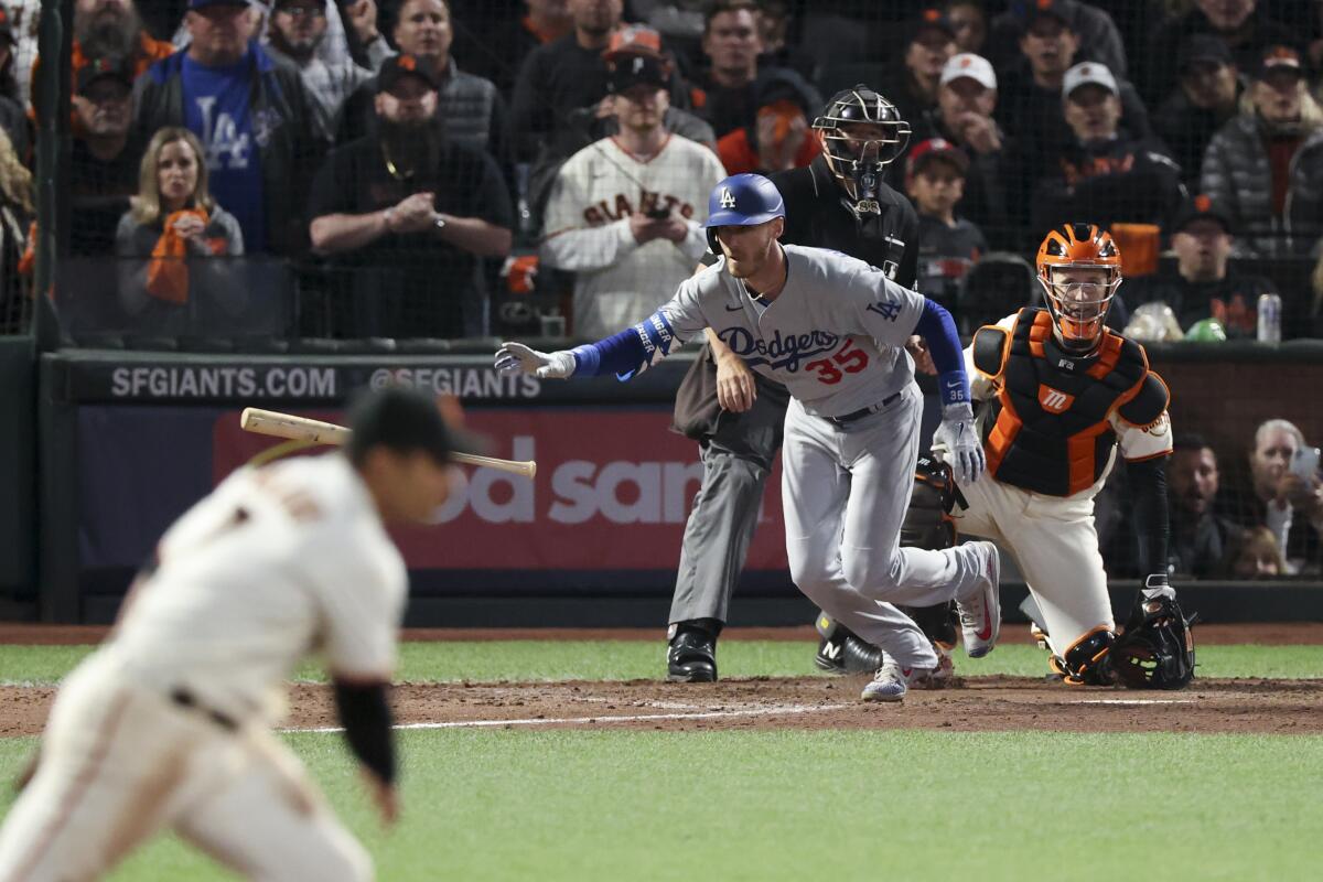 Dodgers' Cody Bellinger tosses his bat after hitting an RBI single during the ninth inning.