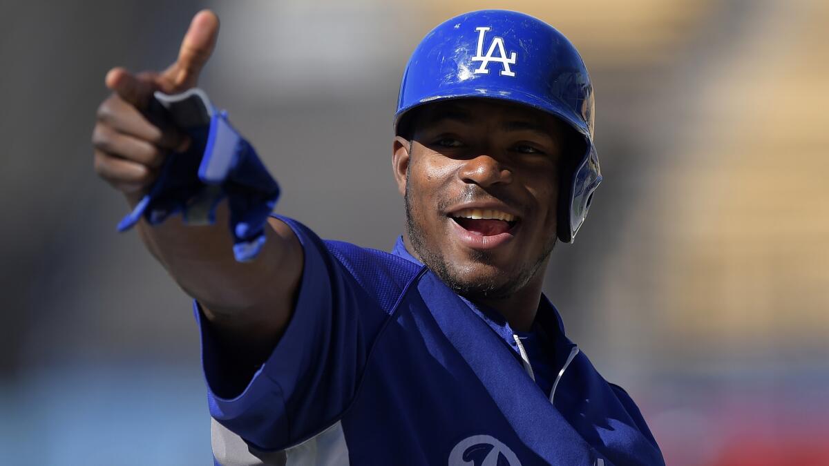 Dodgers right fielder Yasiel Puig acknowledges fans during batting practice before Friday's game against the San Diego Padres at Dodger Stadium. Detroit Tigers outfielder Torii Hunter says it's fun to watch Puig throw.