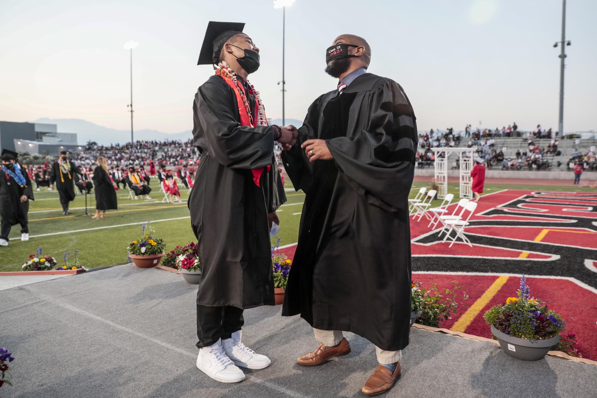 Sierra Vista High Principal Vince Pratt offers a warm congratulations to Johnny Sen at graduation.