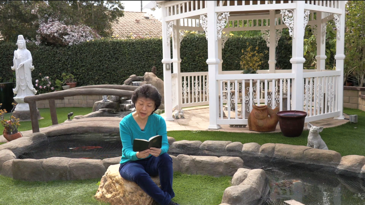 Ding-jo Currie, a Huntington Beach resident of the Baha’i Faith, reads a prayer.