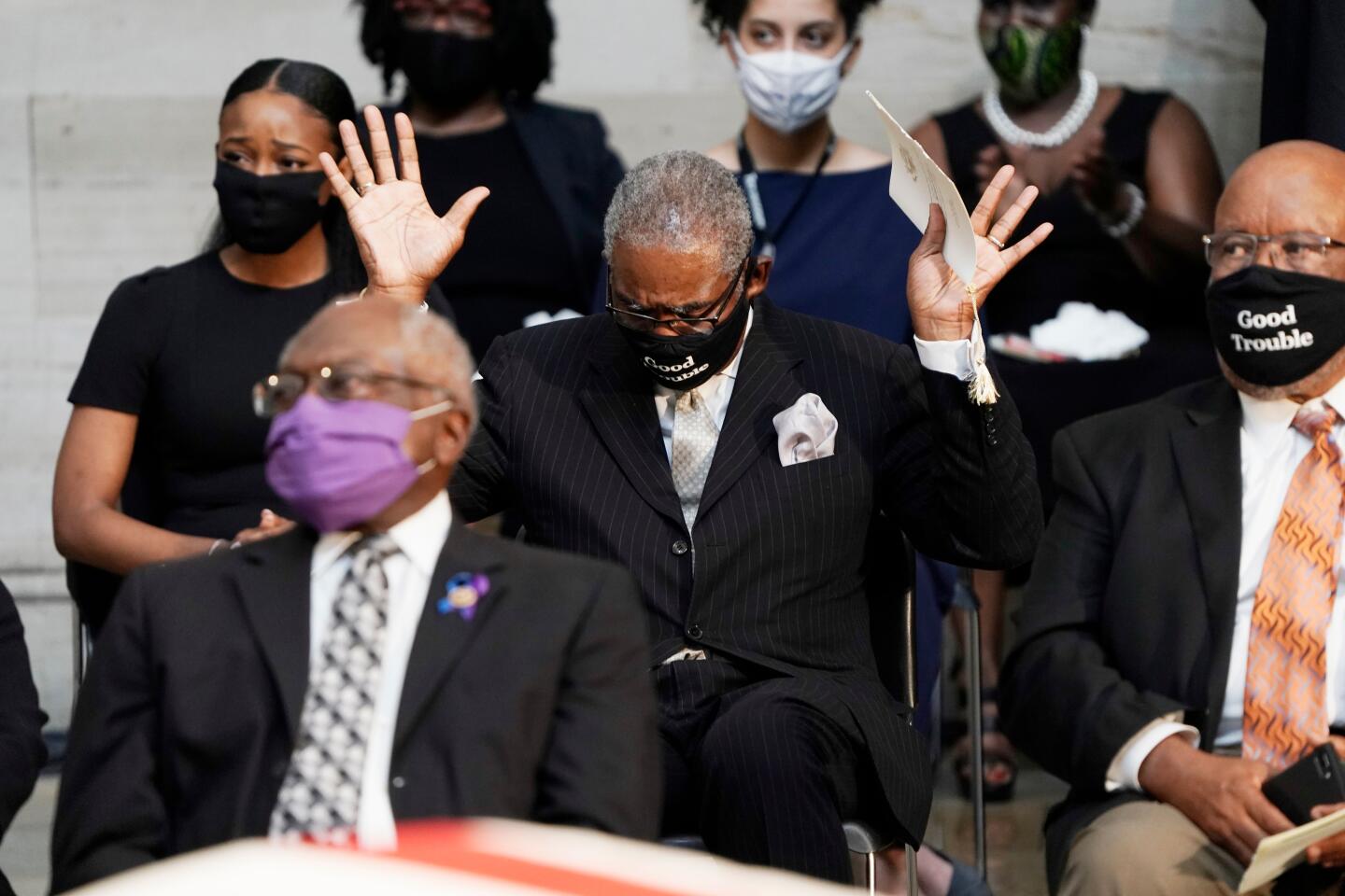 Rep. Gregory Meeks, D-NY, raises his hands as Amazing Grace is played during the ceremony for the late Rep. John Lewis in the Rotunda of the US Capitol in Washington, DC.