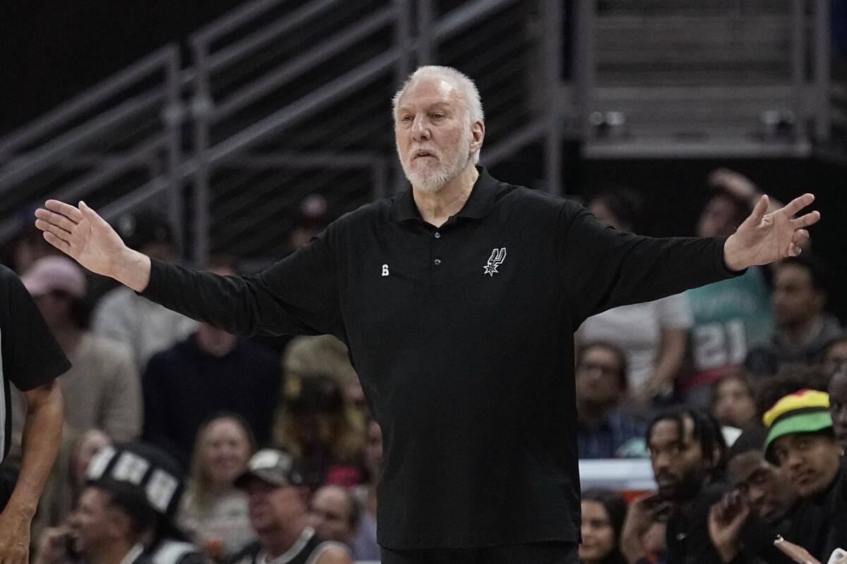 Gregg Popovich gestures at a basketball game.