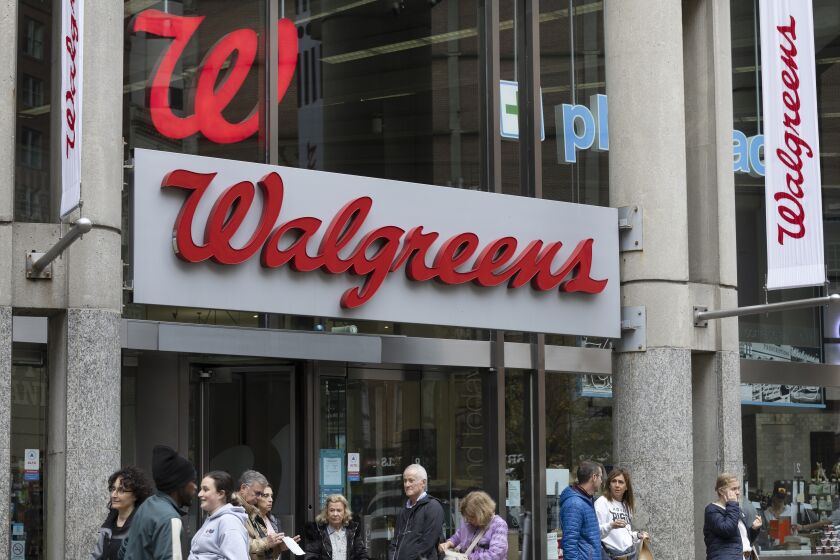 FILE - The entrance to a Walgreens is seen on Oct. 14, 2022, in Boston. A decline in COVID-19 vaccinations and another opioid settlement cut into Walgreens second-quarter earnings, but the drugstore chain still delivered better-than-expected results. Walgreens said Tuesday, March 28, 2023, that it recorded 2.4 million vaccinations in its recently completed fiscal second quarter. (AP Photo/Michael Dwyer, File)